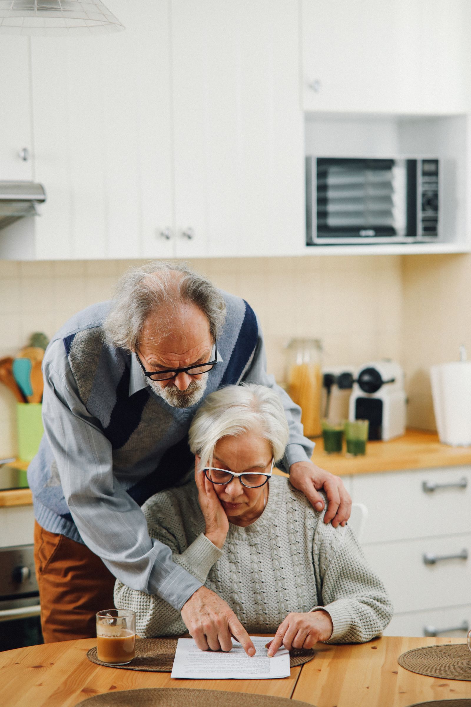 An older couple reading documents together at a table
